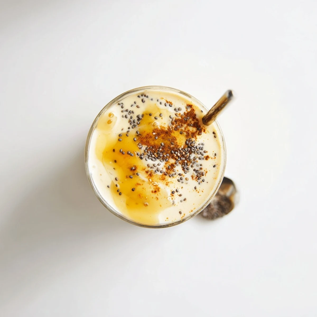 Thick frothy Greek yogurt banana smoothie blending golden yellow bananas with white creamy yogurt in a blender