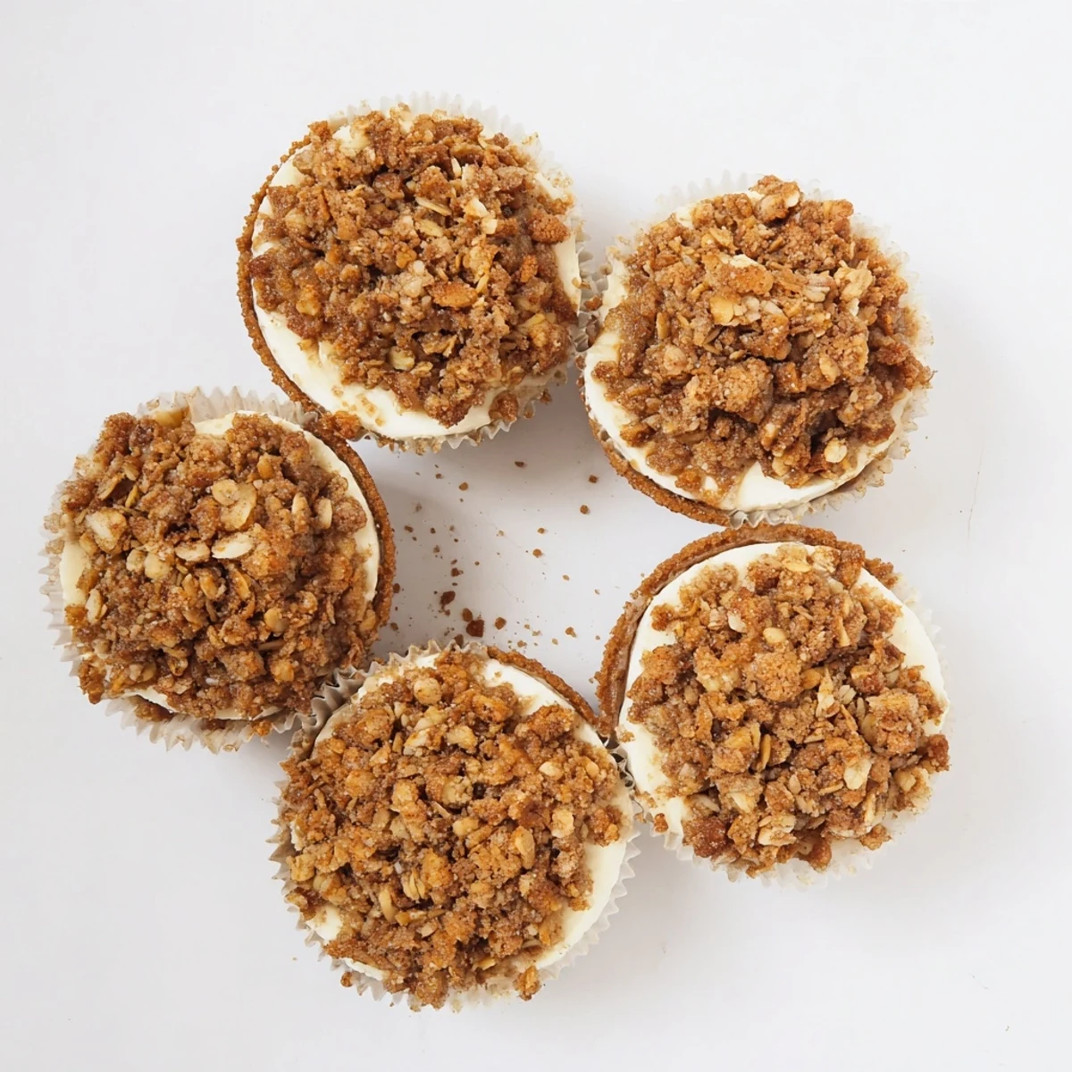 Apple crisp mini cheesecakes featuring tender baked apples over rich vanilla cream cheese filling