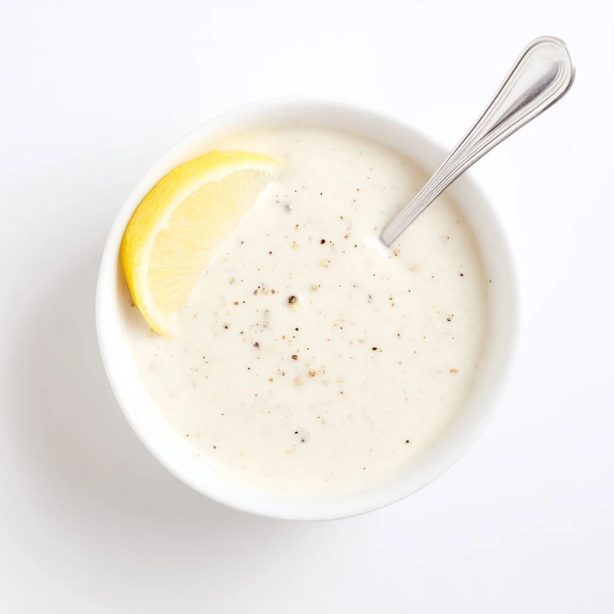 Creamy chicken shawarma garlic sauce drizzled over grilled meat with fresh herbs