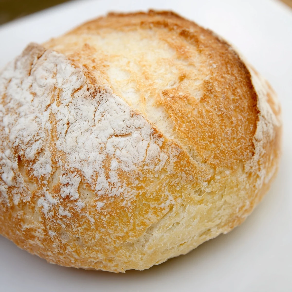 Golden brown crusty French bread rolls freshly baked with flour-dusted tops