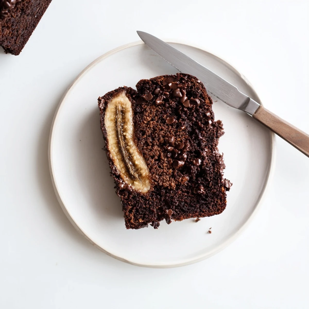 Moist chocolate espresso banana bread loaf studded with melted chocolate chips and dusted with cocoa powder