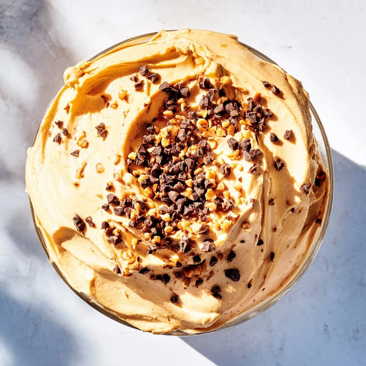 Fluffy peanut butter mousse dessert with light Cool Whip filling garnished with chocolate chips and crushed peanuts for easy entertaining
