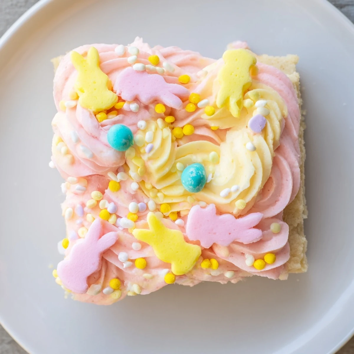 Soft Easter sugar cookie bars with thick pastel frosting and rainbow sprinkles on a festive platter