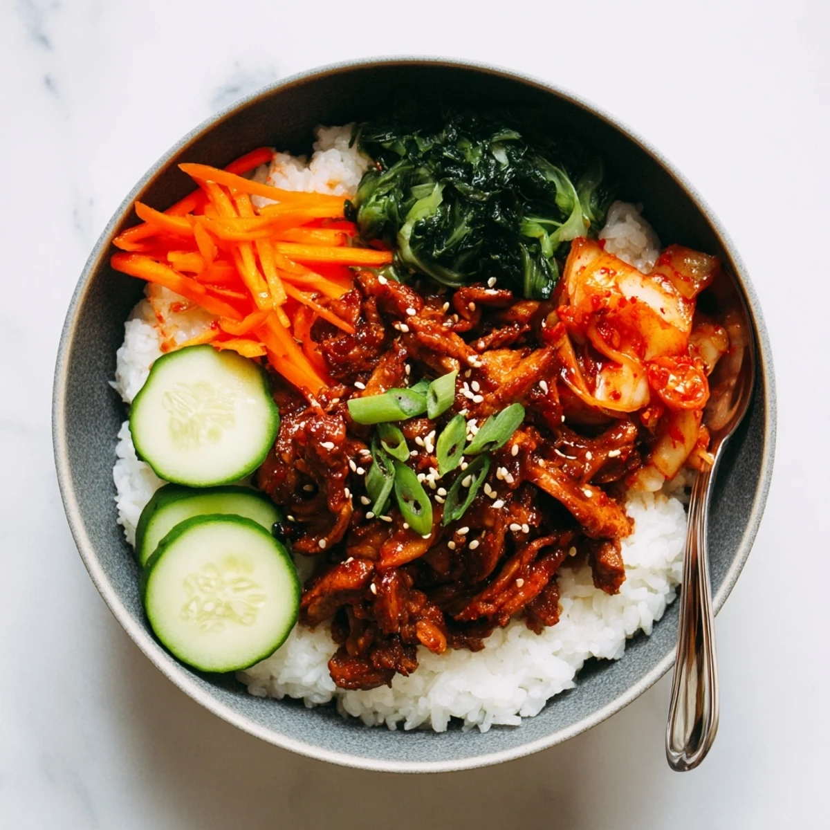 Golden crispy shredded tofu bulgogi bowl over warm rice with julienned carrots