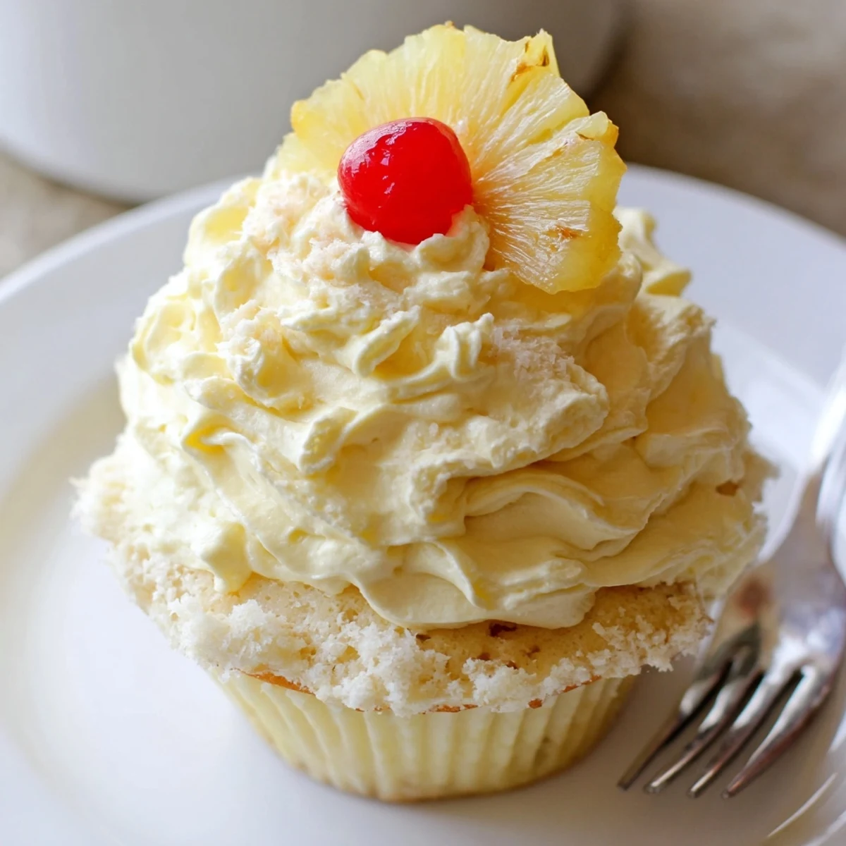 Homestyle Dole Whip Cupcakes Recipe topped with creamy pineapple frosting and cherry