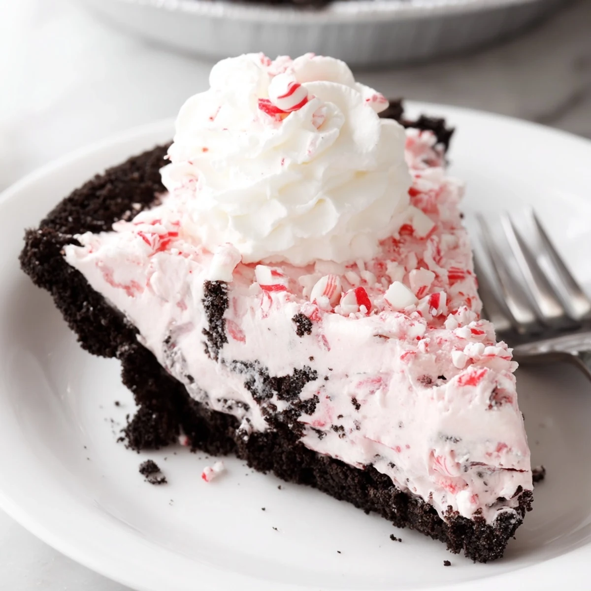 Candy Cane Pie with creamy peppermint filling, chocolate crust, and crushed candy