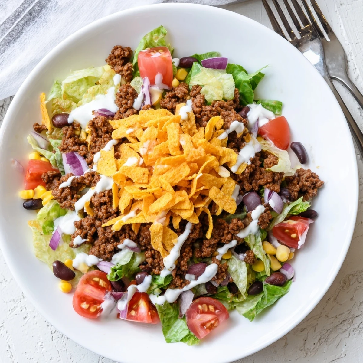 Bowl of Simple Doritos Taco Salad with warm taco beef and creamy ranch.