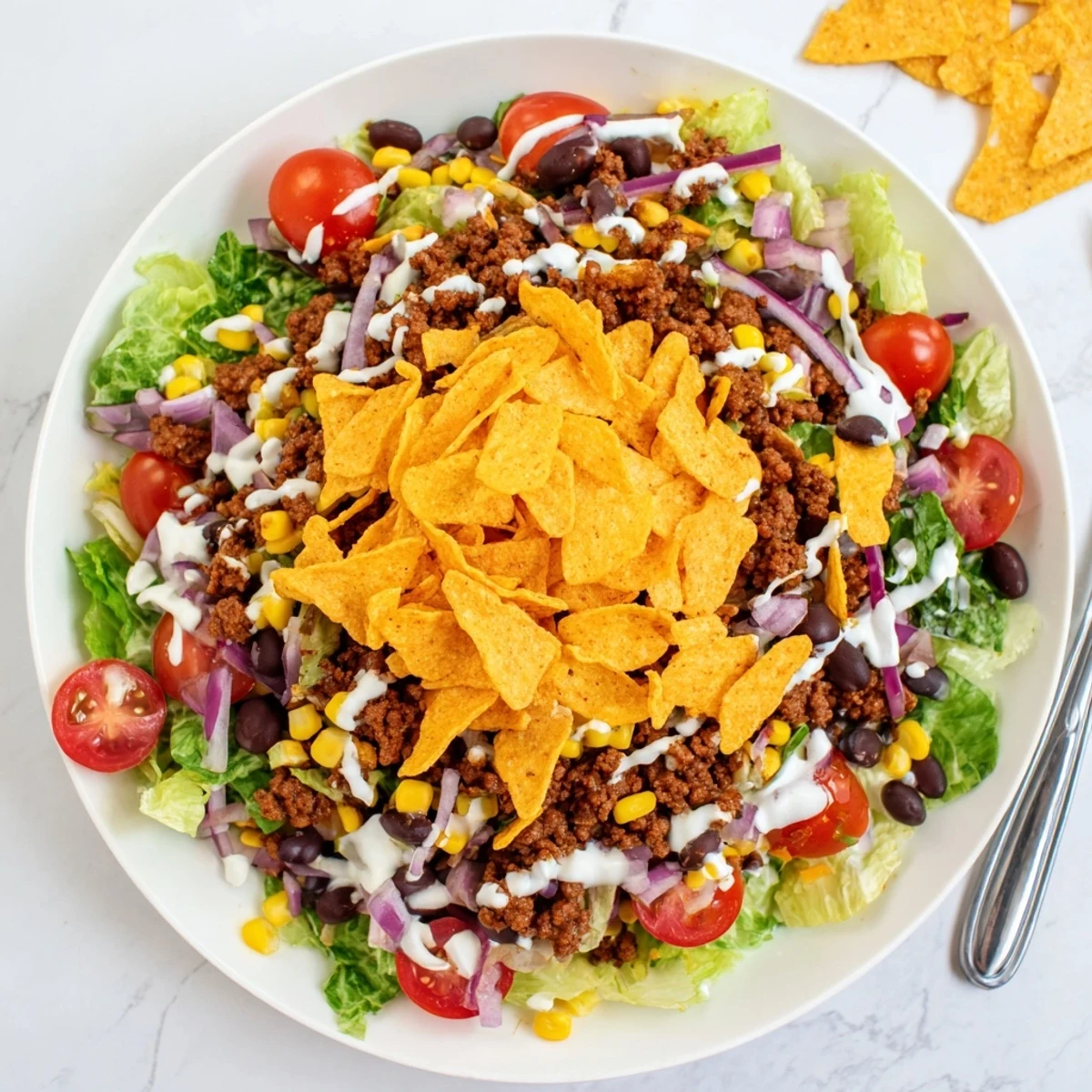 Family-style Simple Doritos Taco Salad tossed just before serving to keep chips crunchy.