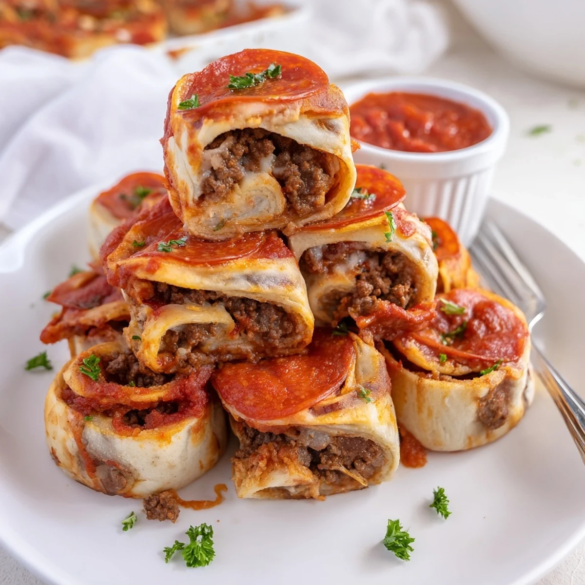 Cheesy Beef Pepperoni Pizza Roll Ups steaming, golden-brown, served with marinara dip
