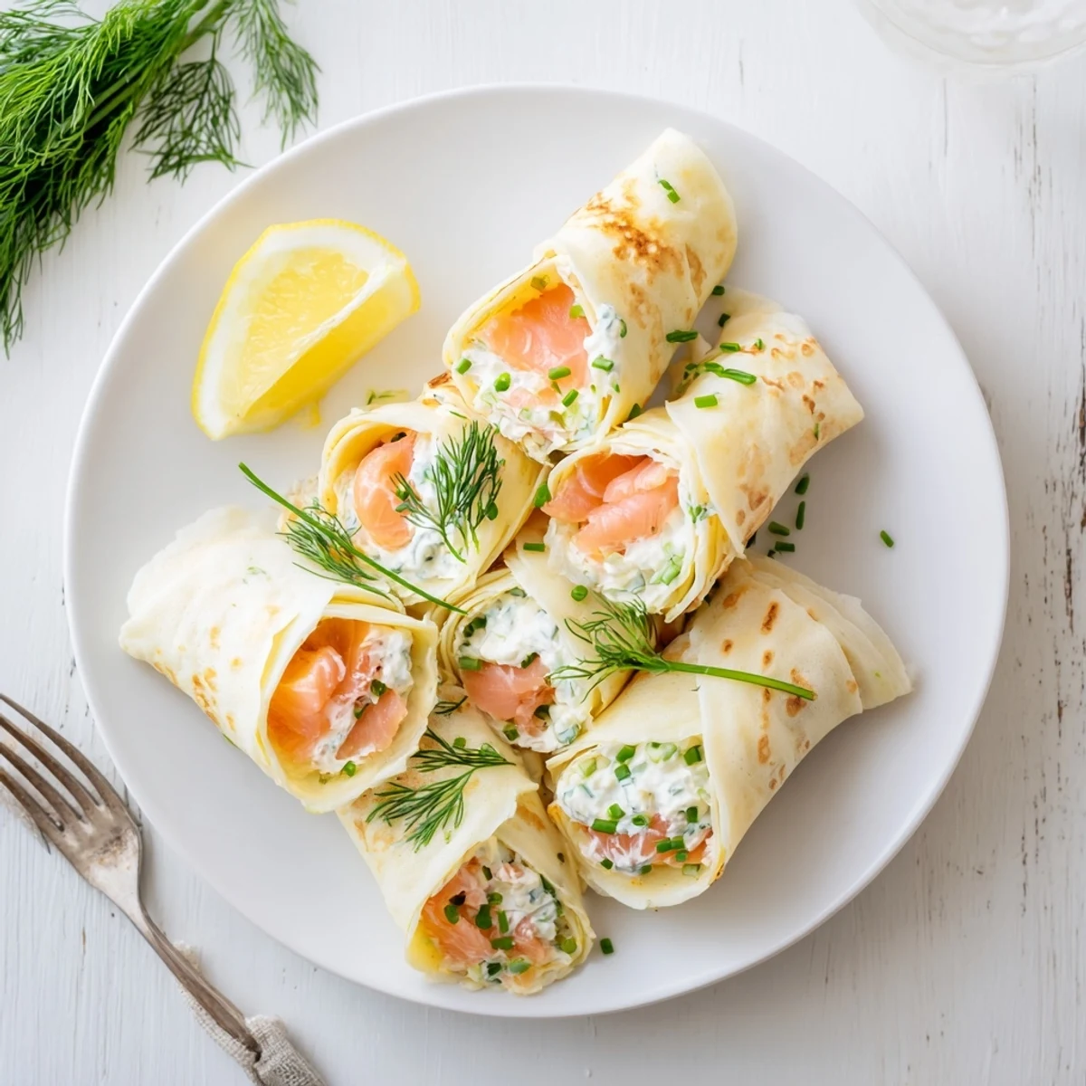 Delicate French crepes wrapped around silky smoked salmon with tangy lemon wedge garnish