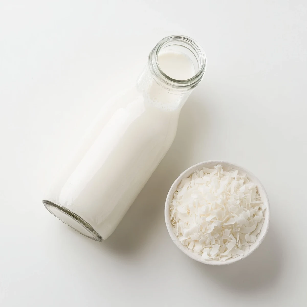 Fresh homemade coconut milk in glass jar with rich creamy white texture