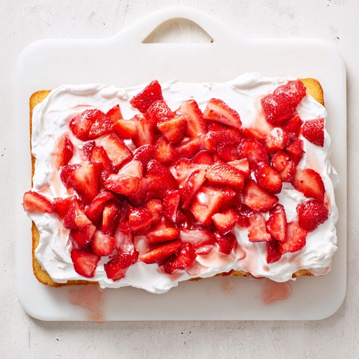 Crowd-pleasing strawberry shortcake sheet cake featuring tender sponge layers with whipped cream topping and vibrant strawberries