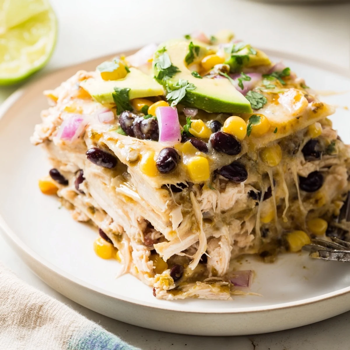 Salsa Verde Chicken Casserole layered with tortilla strips, black beans, served warm