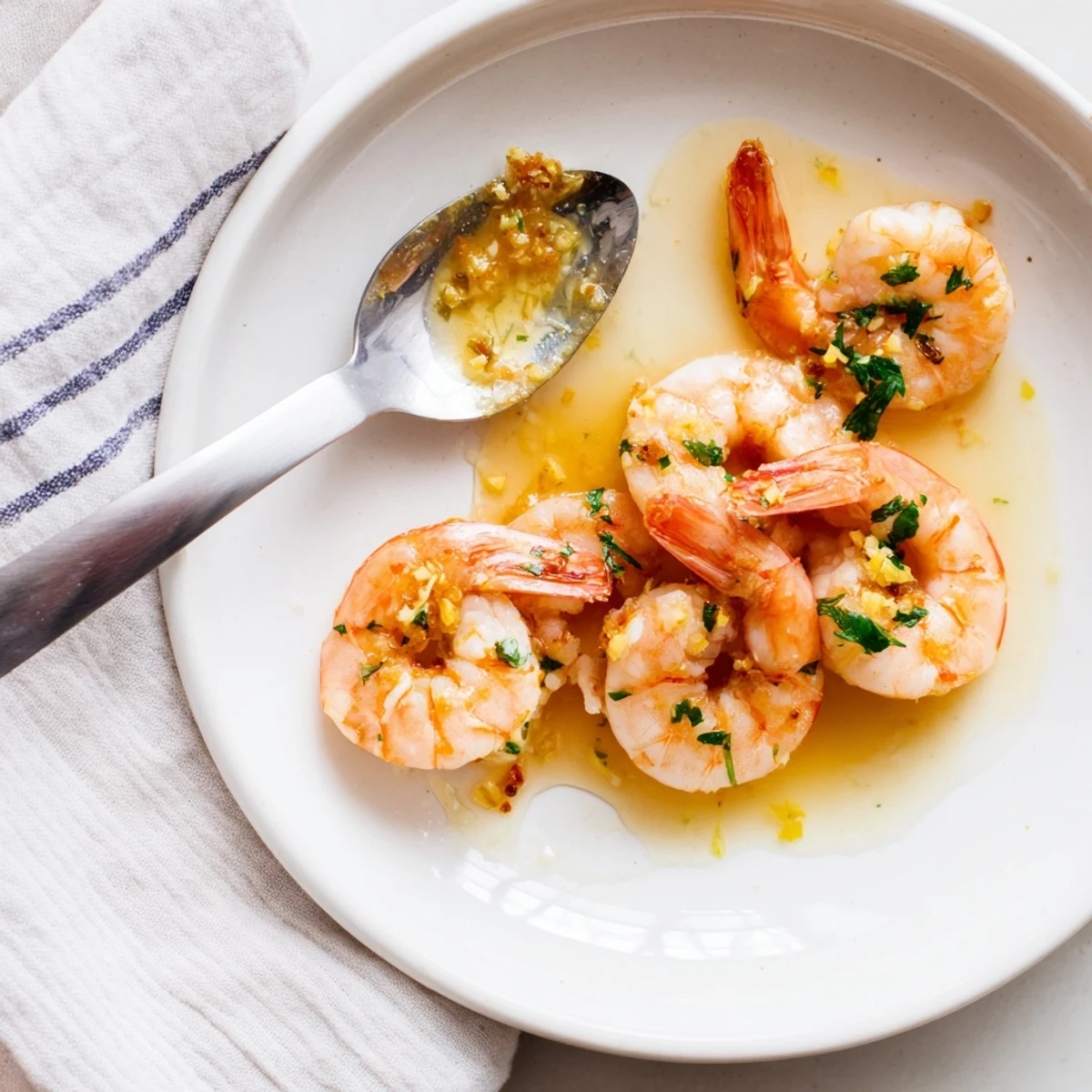 Glistening buttered shrimp in golden garlic sauce topped with fresh chopped parsley