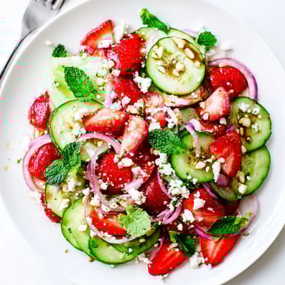 Bright Cucumber Strawberry Salad tossed with toasted almonds, ideal with grilled chicken.